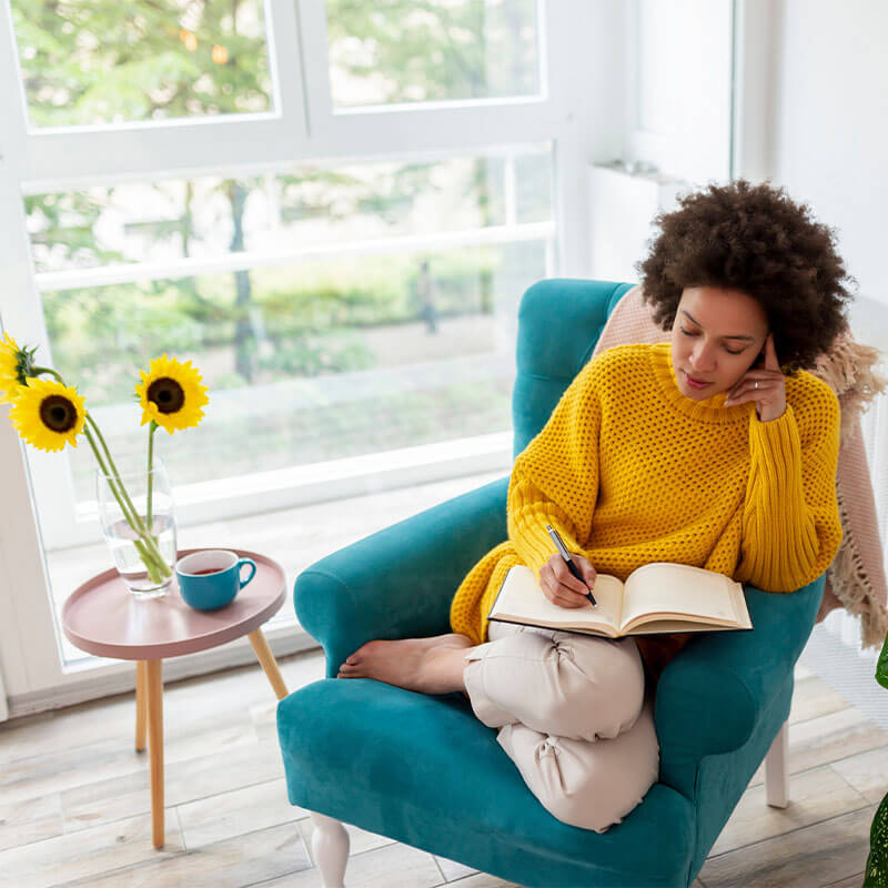 Woman Journaling in Chair